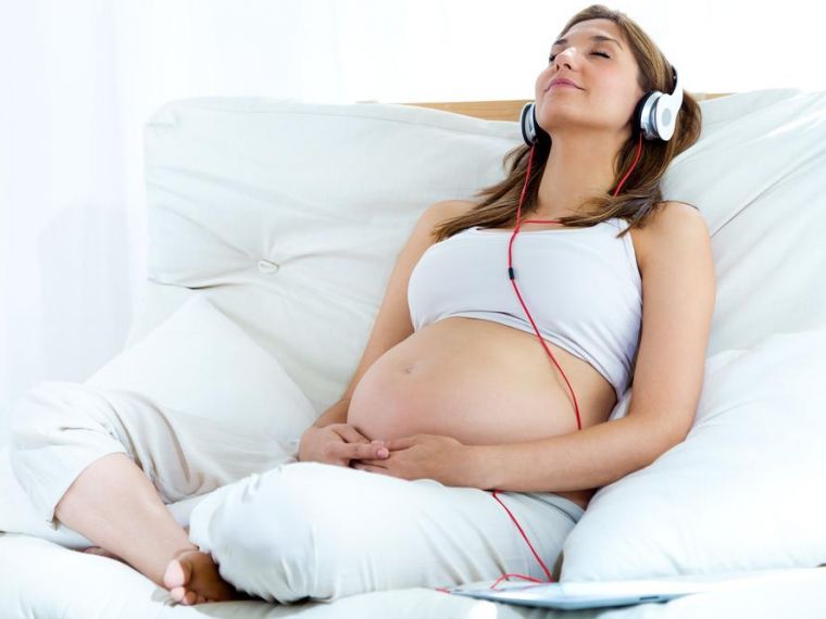 Woman listening to hypnobirthing mp3 for pregnancy and antenatal support